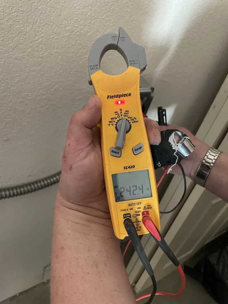 Voltage testing with clamp meter during Recessed Lighting Installation in Centerville
